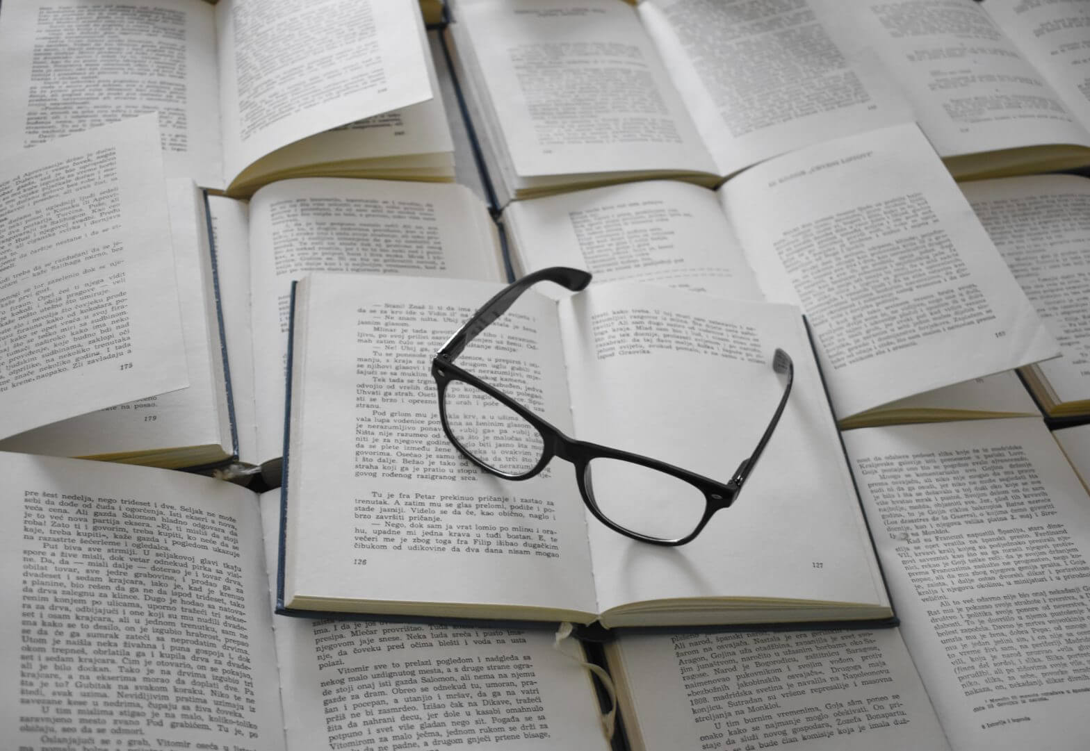 Eyeglasses on open books